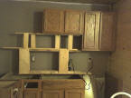 Hanging the kitchen cabinets.